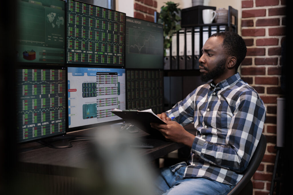 Trader optimizing MetaTrader for faster trade execution, analyzing financial charts on multiple monitors for better market performance.